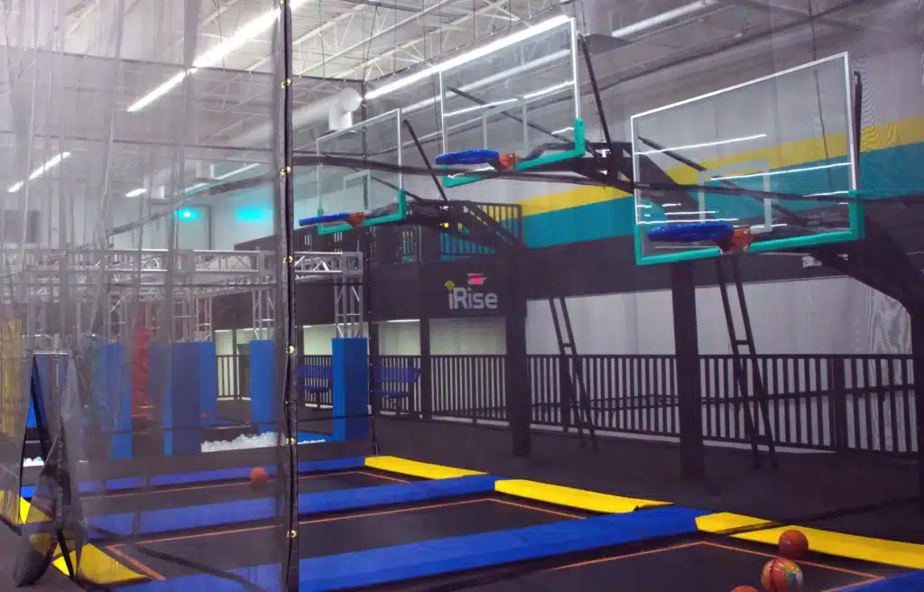 A trampoline park with several different types of trampolines.