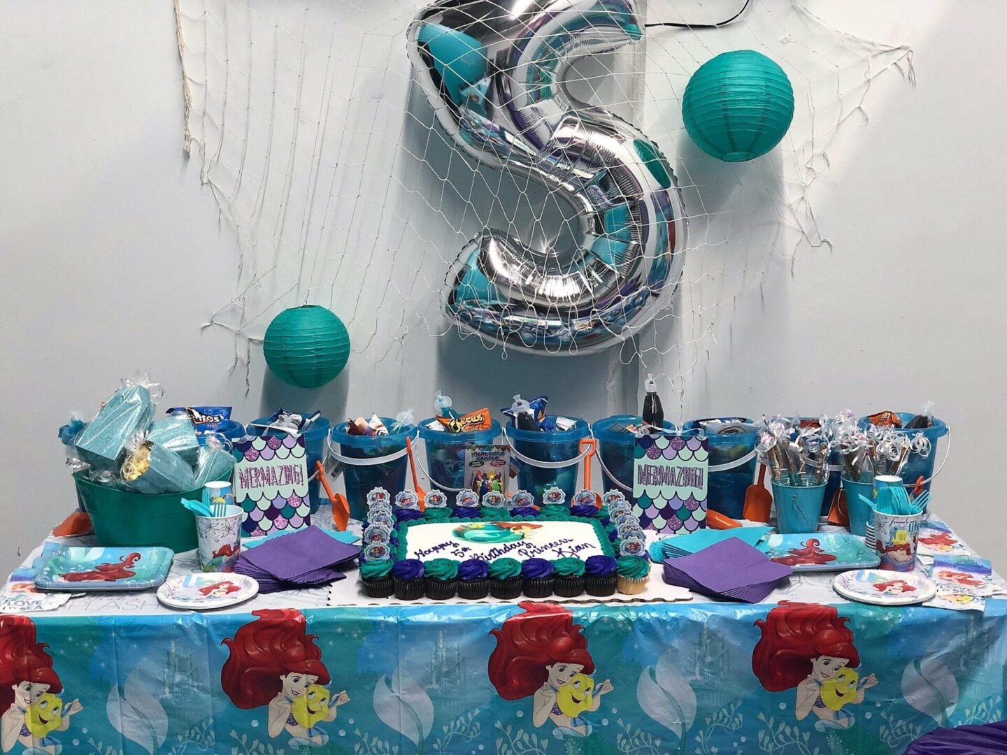 A table with a cake and balloons on it