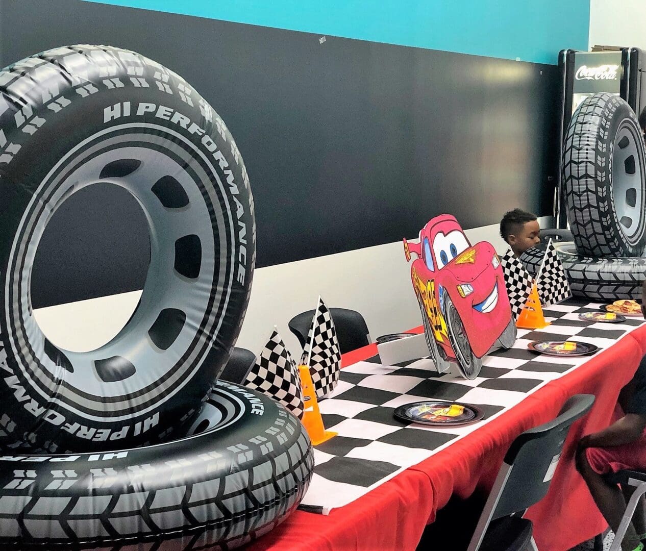 A table with checkered tablecloth and many tires on it