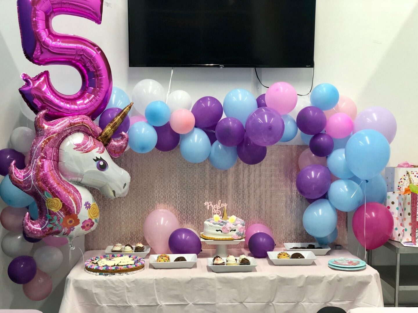 A table with balloons and cake on it