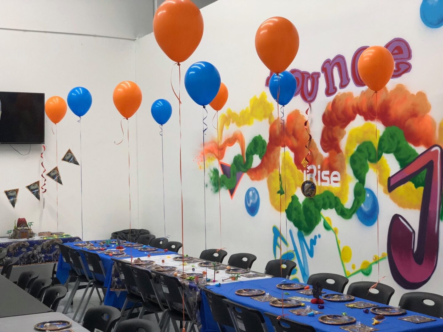 A table with chairs and balloons in the middle of it