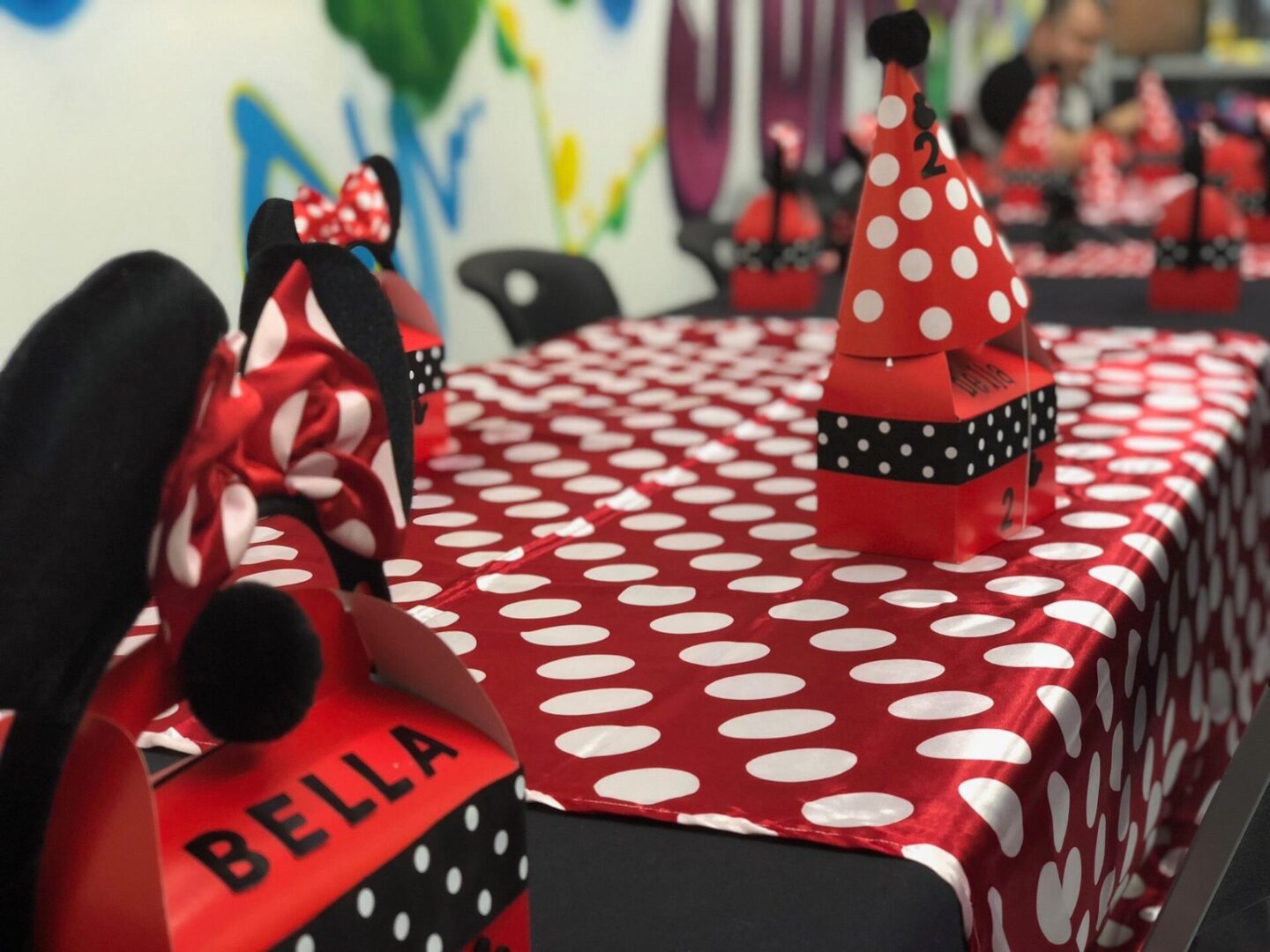 A table with red and white polka dot tablecloth.