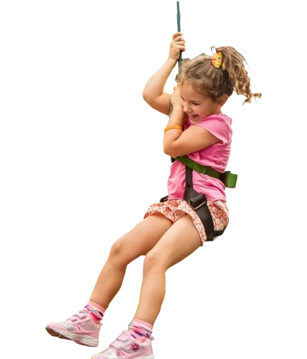 A little girl swinging on a rope swing.