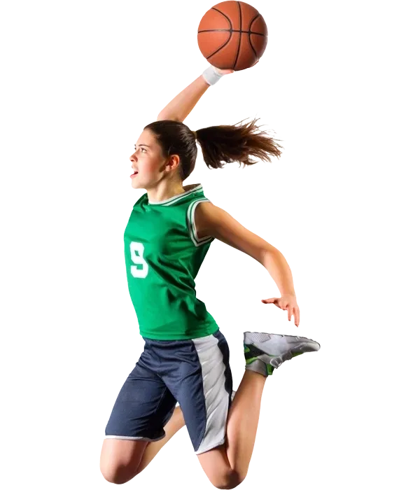 A girl in green shirt and shorts playing basketball.