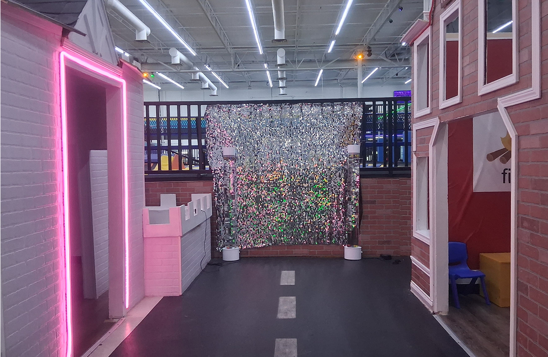 Indoor playground with brick facades and disco wall