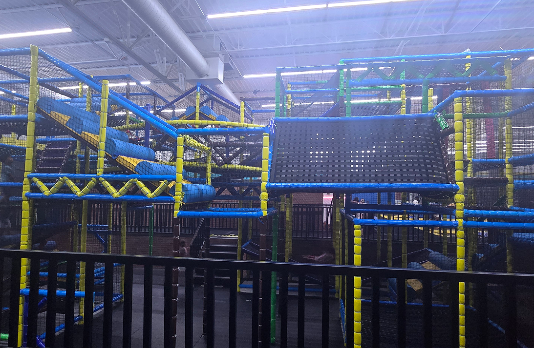 Indoor playground with slides and climbing structures