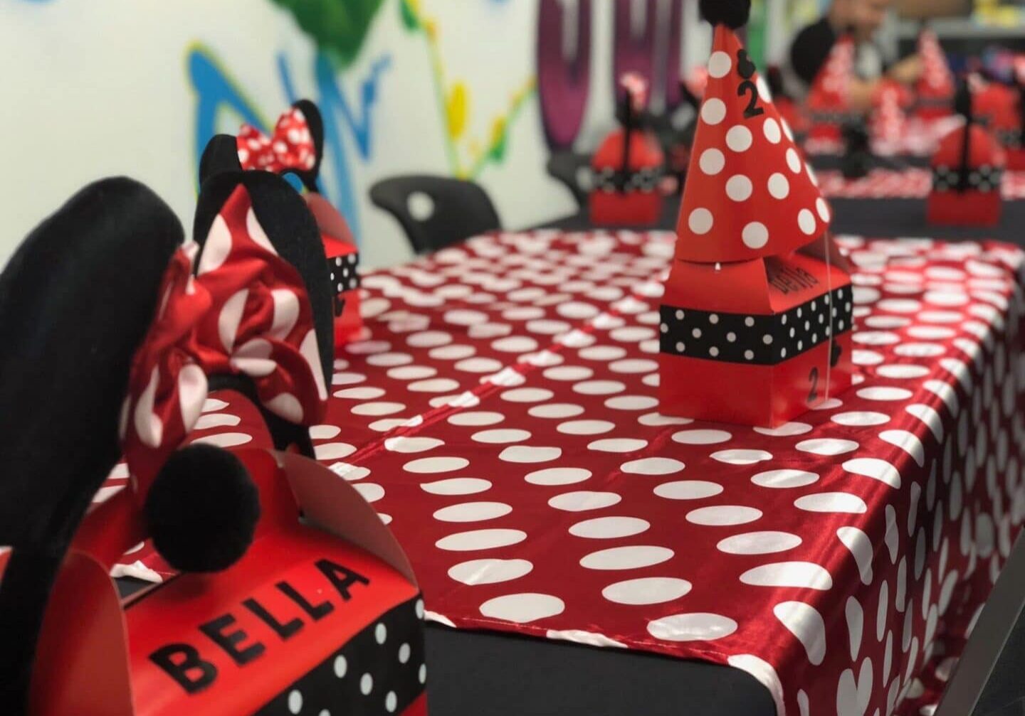 A table with red and white polka dot tablecloth.